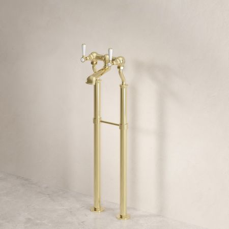 Linton Classic Floor Mounted Bath Filler with 620mm Standpipes & White Levers in Timeless Brass